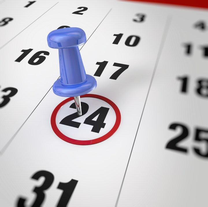 Calendar and blue pushpin. Mark on the calendar at 24.